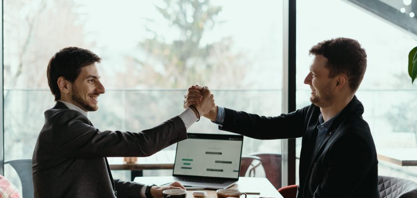 Businessman shaking hand to his partner on meeting, positive management team celebrating victory, successful stock deal, sales growth, won good contract, business achievement and teamwork concept