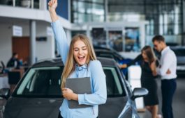 Young family choosing a car in a car showroom